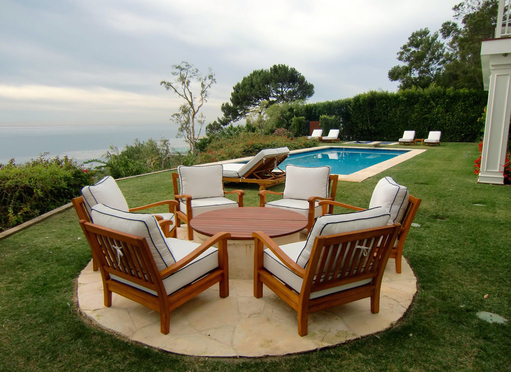 Set up outdoor teak table and chairs that was just refinished by Teak Master