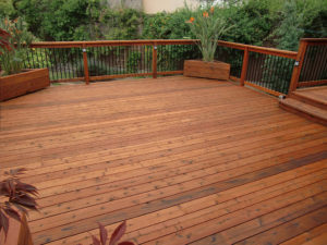 A stunning redwood deck that gives warmth to the surrounding foliage.