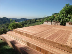 An unfinished and unprotected redwood deck overlooking the California hills.