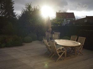 A teak deck with table outside at sunset