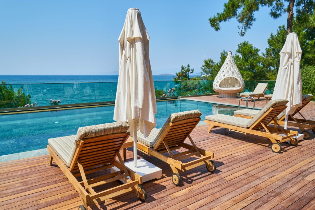 outdoor deck furniture lounge chairs by a pool