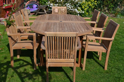 teak lawn furniture set with chairs and a table
