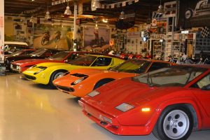 a line of classic sports cars in a garage