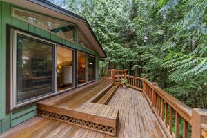 The wooden deck of a house in the woods