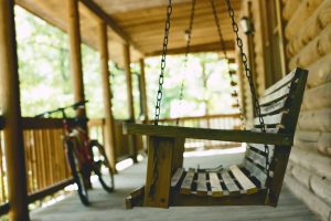 Outdoor swinging chair on a front porch