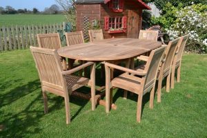 teak furniture garden patio set sitting in a beautiful backyard