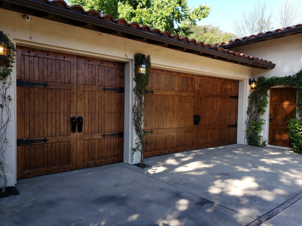 A brown wooden garage door that has been refinished by Teak Master
