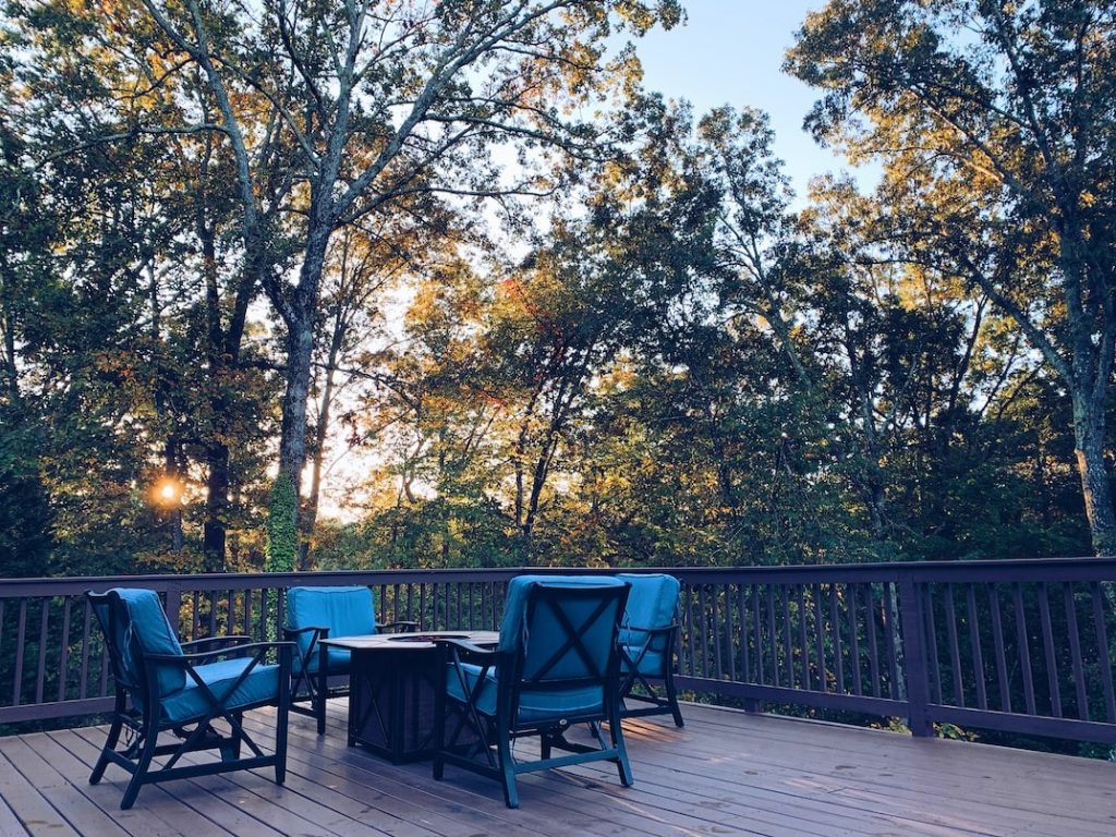 Outdoor furniture on a back porch in the forest