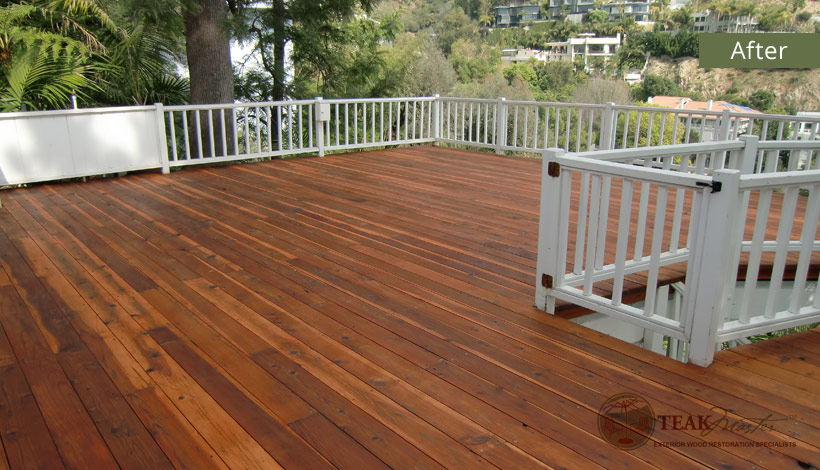 A redwood deck balcony, returned to its former luster and glow thanks to Teak Masters.