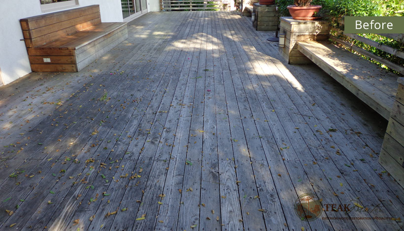 A weather-beaten and sun-dried redwood deck with barely any life left in it.