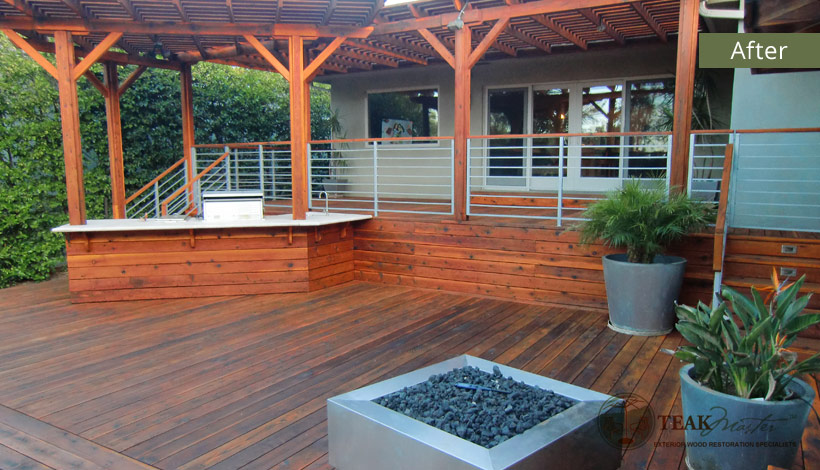 An after image when Teak Masters has finished restoring a family deck made of redwood including the serving counter and attached barbeque grill.