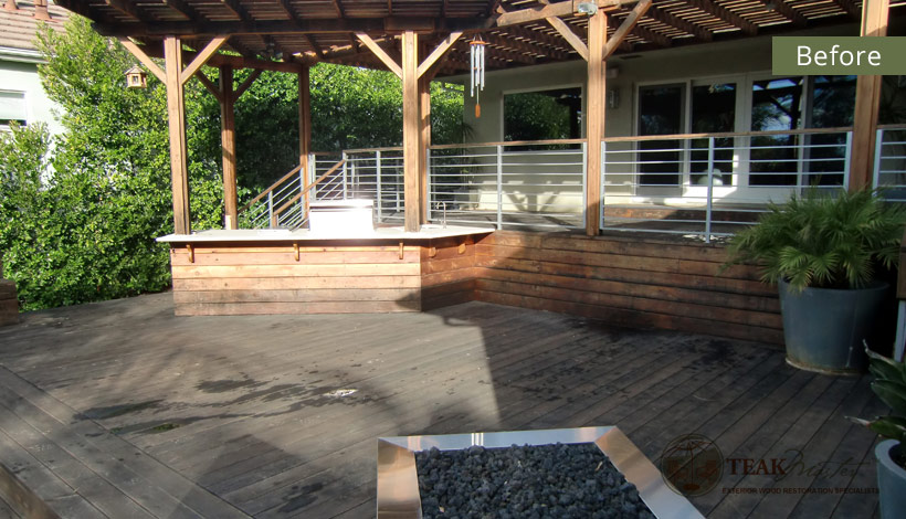 The dark and dreary view of a redwood deck that has been used and neglected for years before Teak Masters started their restoration process.